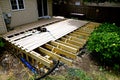 A partially constructed exterior deck with joists and posts in place Royalty Free Stock Photo