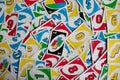 Deck of Uno game cards scattered all over on a table. American card game.