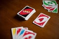 Deck of Uno game cards scattered all over on a table. American card game. Royalty Free Stock Photo