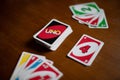 Deck of Uno game cards scattered all over on a table. American card game.