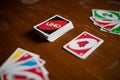 Deck of Uno game cards scattered all over on a table. American card game. Royalty Free Stock Photo