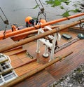 Deck of a wooden sailboat with boom secured in an Irish harbor