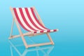 Deckchair with red and white stripe pattern, 3D rendering on blue backdrop