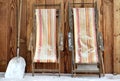 Deckchairs folded  on a terrace covered with snow Royalty Free Stock Photo