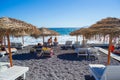 Deckchairs on peaceful morning beach Kamari Black beach Santorini Greece