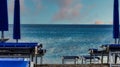 deckchairs on the sandy beach near the sea in July