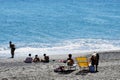 Deckchairs and Swimmers on Sand and Shingle Beach, Savona, Liguria, Italy