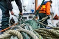 deckhands coiling ropes on a sailing boat deck