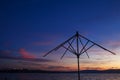 Decline or dawn over the sea. Beautiful clouds of rising or decline are reflected in waves. Silhouette of beach umbrella Royalty Free Stock Photo