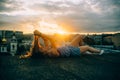 Beautiful woman rests on the roof, hipster portrait outdoors, sunset time, city, rest time, light, hipster photo, happy face, smil Royalty Free Stock Photo