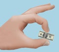 The declining value of the US dollar is illustrated with a tiny one-hundred dollar bill Royalty Free Stock Photo