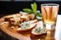 a deconstructed shot revealing apple slices, gorgonzola, and a slice of bruschetta