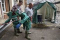 Decontamination tent and men removing their protective clothing