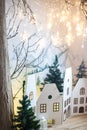 decor in the children`s room for Christmas. Cardboard houses, mountains on the wall, tree with Christmas garland Royalty Free Stock Photo