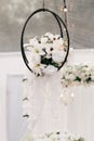 Decor element in the form of hanging white orchids for the wedding ceremony Royalty Free Stock Photo