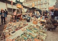 Decor elements, fashion stuff and vintage bargains for sale on outdoor flea market with young visitors