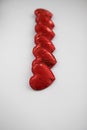 decor in the form of hearts made of red fabric lie on a white background Royalty Free Stock Photo