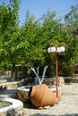 A large clay pot or amphora lies as decoration in the garden. Lardos, Rhodes Island, South Aegean region, Greece Royalty Free Stock Photo