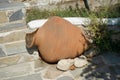 A large clay pot or amphora lies as decoration in the garden. Lardos, Rhodes Island, South Aegean region, Greece Royalty Free Stock Photo