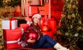 Decor shop. Favorite color. Red style. Spread love. Winter holiday. Small cute girl with big ball christmas tree Royalty Free Stock Photo