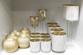 Decor shop. Shelf with gold and white candlesticks