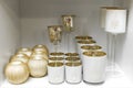 Decor shop. Shelf with gold and white candlesticks Royalty Free Stock Photo