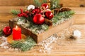 Decor to celebrate the new year and Christmas. a burning candle and a wooden box with Christmas balls, branches, cones Royalty Free Stock Photo