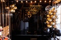 Decor to the 35th anniversary. black wall with a gold inscription happy birthday 35 and with black and gold balloons, candy bar.