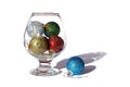 Christmas toys in a glass cup on a white background Royalty Free Stock Photo