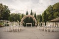 wedding ceremony in a restaurant garden: floral arch and rows white chairs Royalty Free Stock Photo
