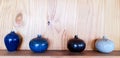 Decorate variety ceramic vase and flower pot on wooden shelf and wall background