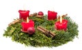 Decorated advent wreath made of fir branches with burning red candles