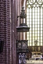 Interior of a brick cathedral in the Gothic style. A decorated anbon and a large stained glass window.