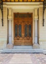 Decorated antique wooden door in a stone bricks wall, Abdeen Palace, Cairo, Egypt