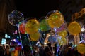 Decorated balloons, lights and Christmas celebration at illuminated Park street with joy and year end festive mood. Dark sky