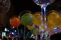 Decorated balloons, lights and Christmas celebration at illuminated Park street with joy and year end festive mood. Dark sky