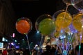 Decorated balloons, lights and Christmas celebration at illuminated Park street with joy and year end festive mood. Dark sky