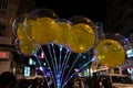 Decorated balloons, lights and Christmas celebration at illuminated Park street with joy and year end festive mood. Dark sky