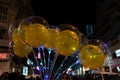 Decorated balloons, lights and Christmas celebration at illuminated Park street with joy and year end festive mood. Dark sky