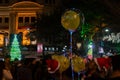 Decorated balloons, lights and Christmas celebration at illuminated Park street with joy and year end festive mood. Dark sky