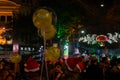 Decorated balloons, lights and Christmas celebration at illuminated Park street with joy and year end festive mood. Dark sky