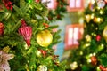 Decorated with balls and baubles Christmas tree near a retro wooden house. Preparing for the new year and Christmas celebrations Royalty Free Stock Photo
