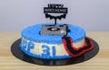 Decorated birthday cake with happy birthday stick pinned. Camera-themed round cake for the 31st birthday celebration for the