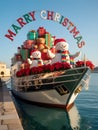 A Decorated Boat Floats on Water, with Gifts and Two Snowmen Royalty Free Stock Photo