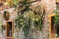 Decorated brick wall with farmer tools and wheat and leaves