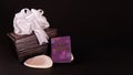 Decorated brown lether box with silver ribbon and happy anniversary mini message book with seashell on black background.