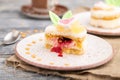 Decorated cake with milk and coconut cream with cup of coffee on a gray wooden background. Side view, selective focus Royalty Free Stock Photo