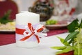 A decorated candle stands on the banquet table