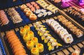 Decorated catering banquet table with different asian sushi rolls and nigiri sushi plate assortment on a party Royalty Free Stock Photo