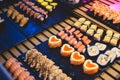 Decorated catering banquet table with different sushi rolls and nigiri sushi plate assortment on a party Royalty Free Stock Photo